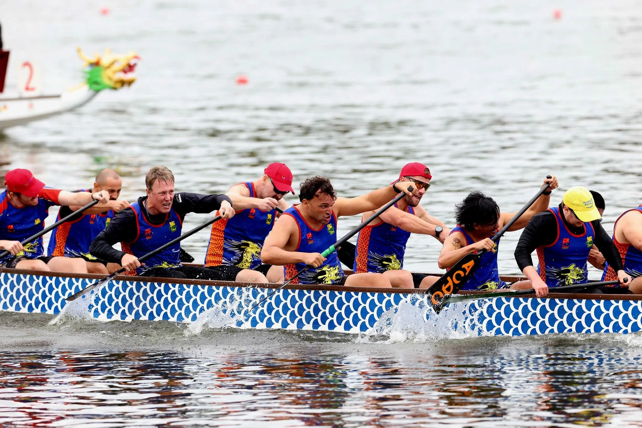 A crew driving through the water at full stroke during a regatta