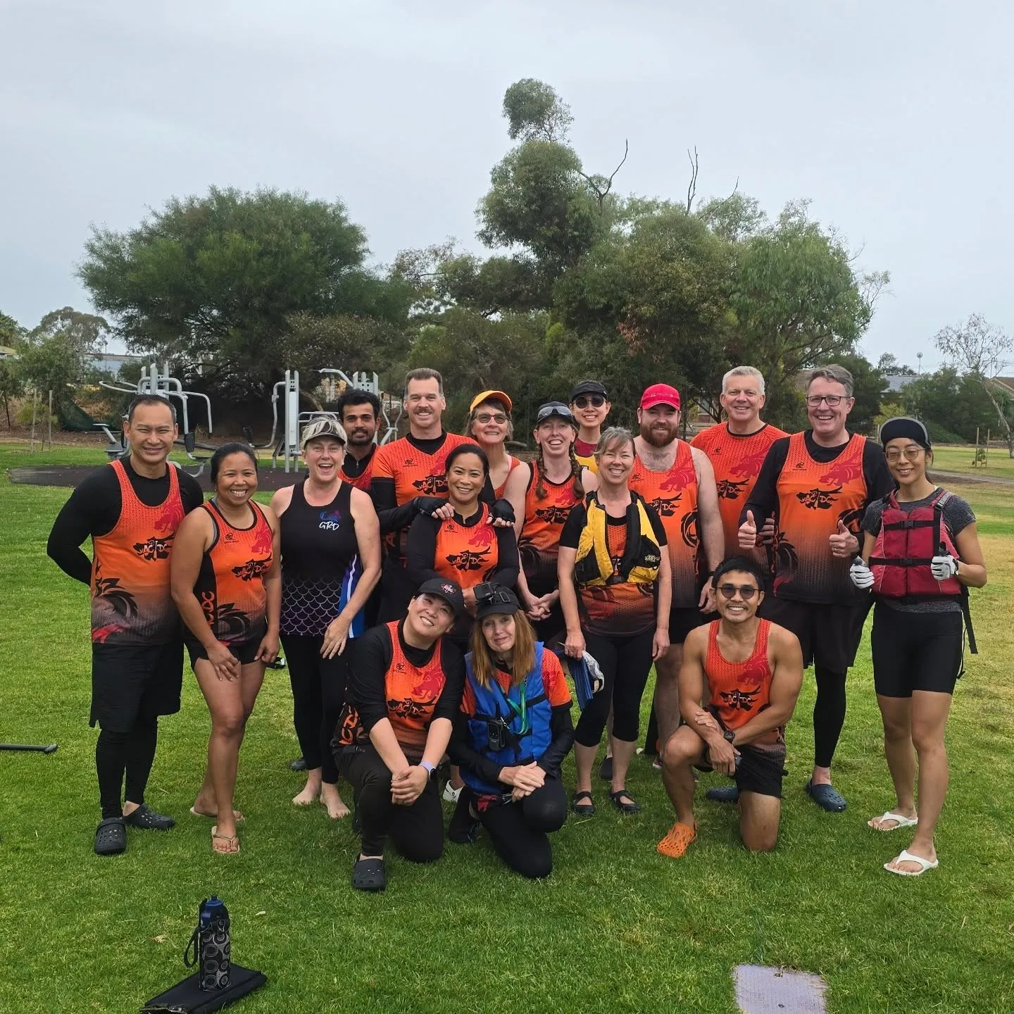 The ACDC squad in orange club kit gathered in the park
